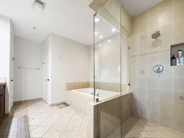 a bathroom with a tub and a shower
