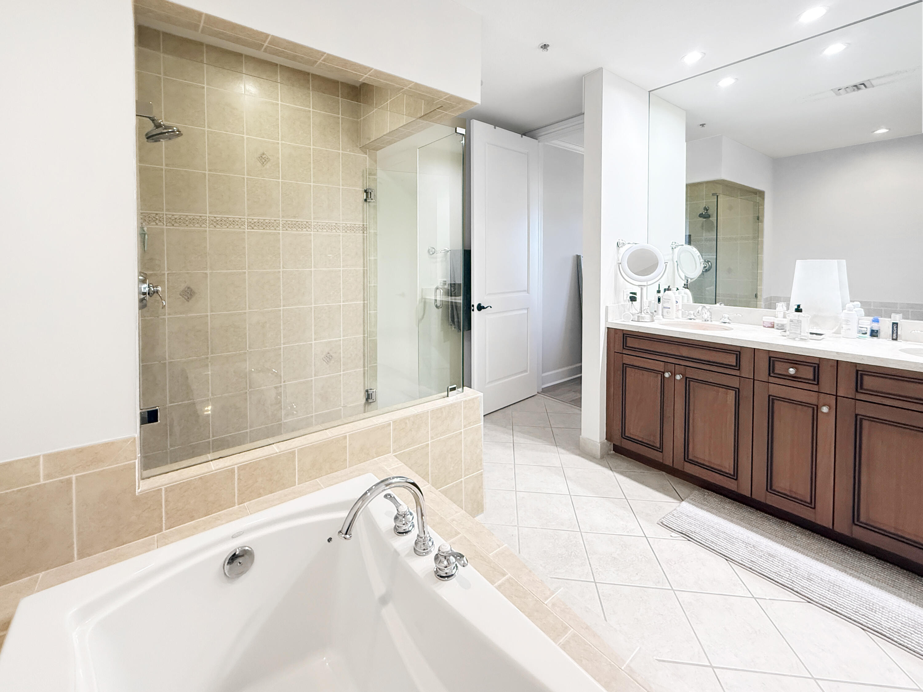 200 Northeast 2nd Avenue, Unit 414 Delray Beach, FL 33444 - Photo 7 of 16 a spacious bathroom with a tub sink and mirror