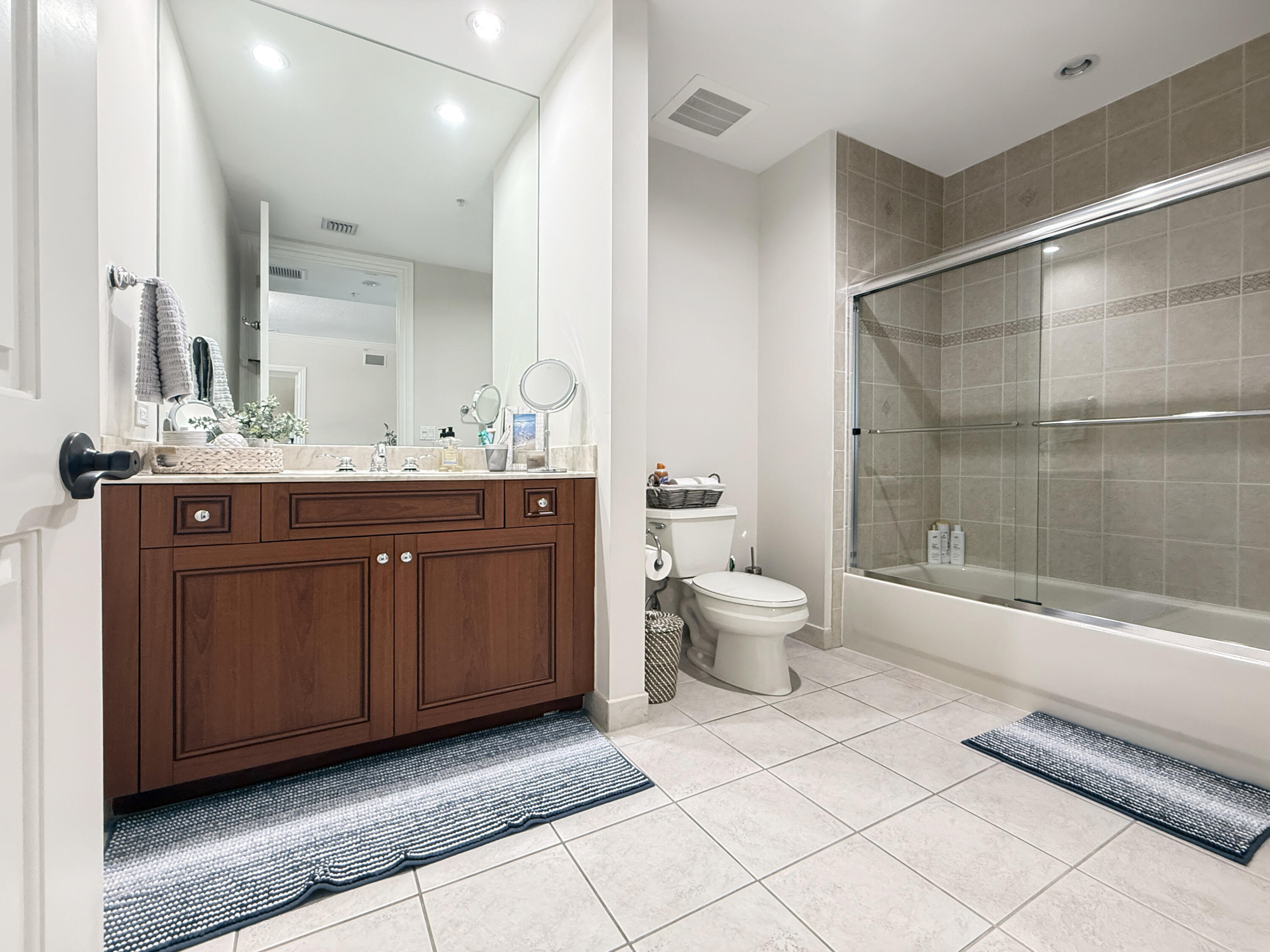 200 Northeast 2nd Avenue, Unit 414 Delray Beach, FL 33444 - Photo 9 of 16 a spacious bathroom with a double vanity sink toilet and shower