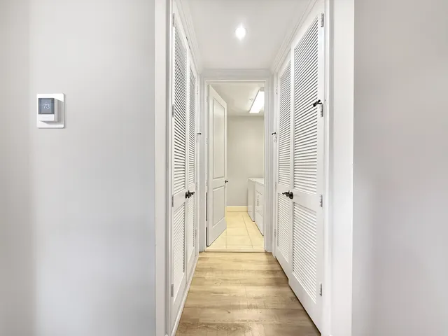 a view of a hallway with a wooden floor