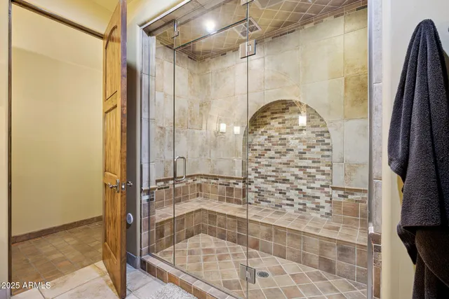 a view of a patio with table and chairs under an umbrella