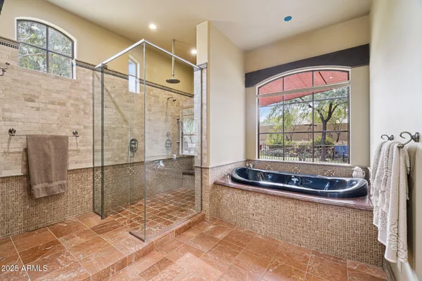 a view of a backyard with table and chairs under an umbrella