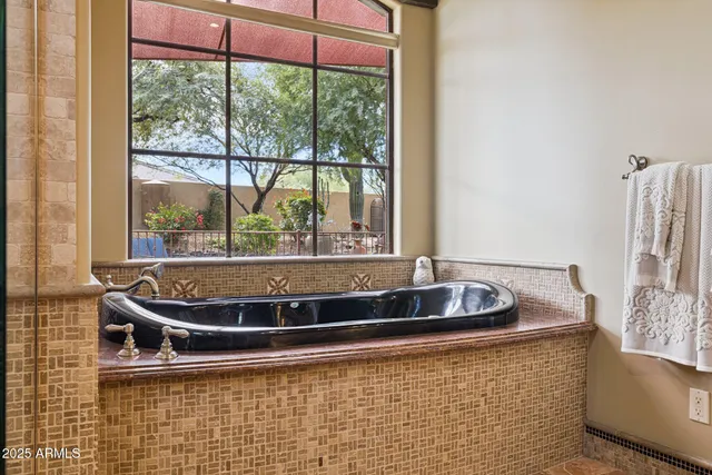 a view of the patio with table and chairs potted plants and large tree