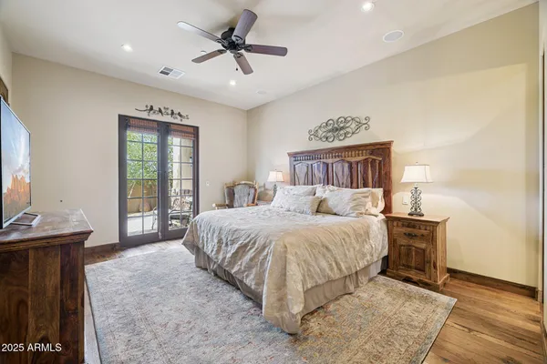 a view of a patio with a table chairs and a floor to ceiling window