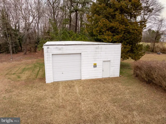 a view of a yard with trees in front of it