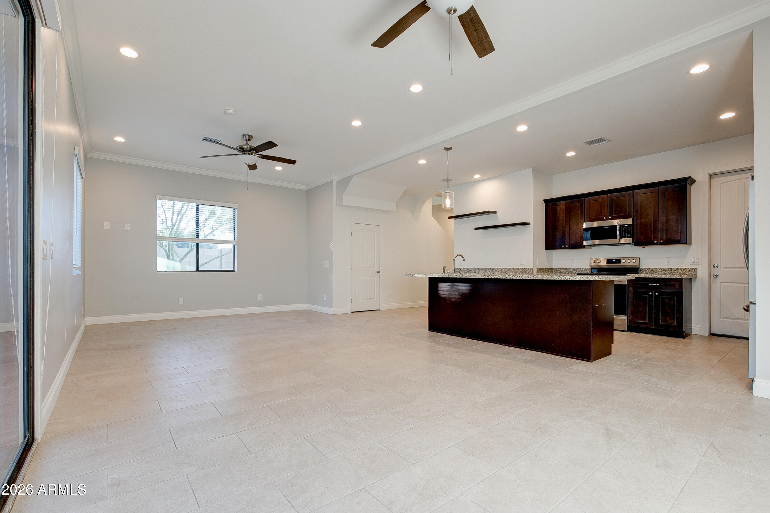 16075 North 30th Street Phoenix, AZ 85032 - Photo 12 of 41 a kitchen with stainless steel appliances granite countertop a stove a sink a refrigerator and a microwave