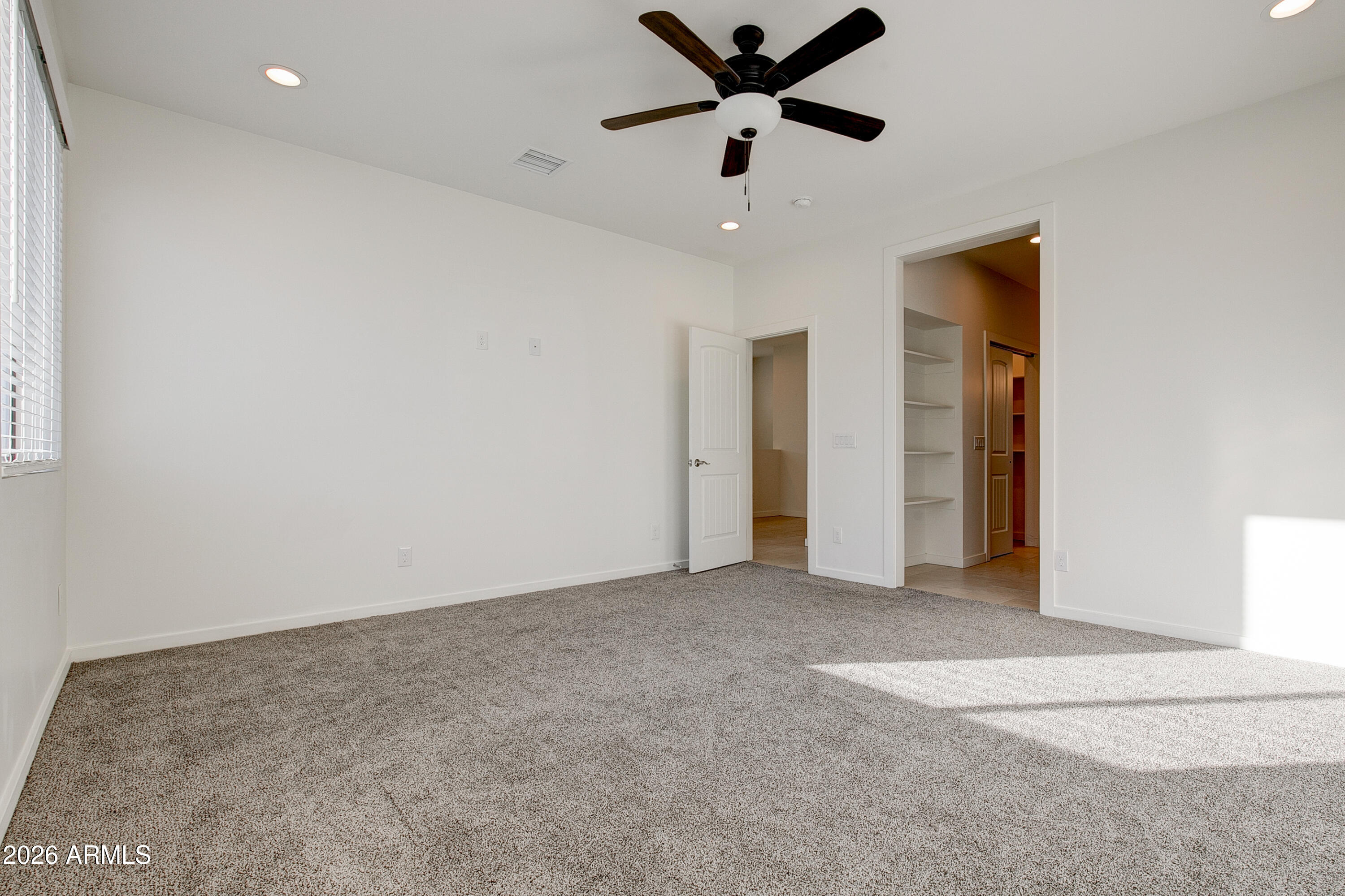 16075 North 30th Street Phoenix, AZ 85032 - Photo 21 of 41 an empty room with closet and a ceiling fan