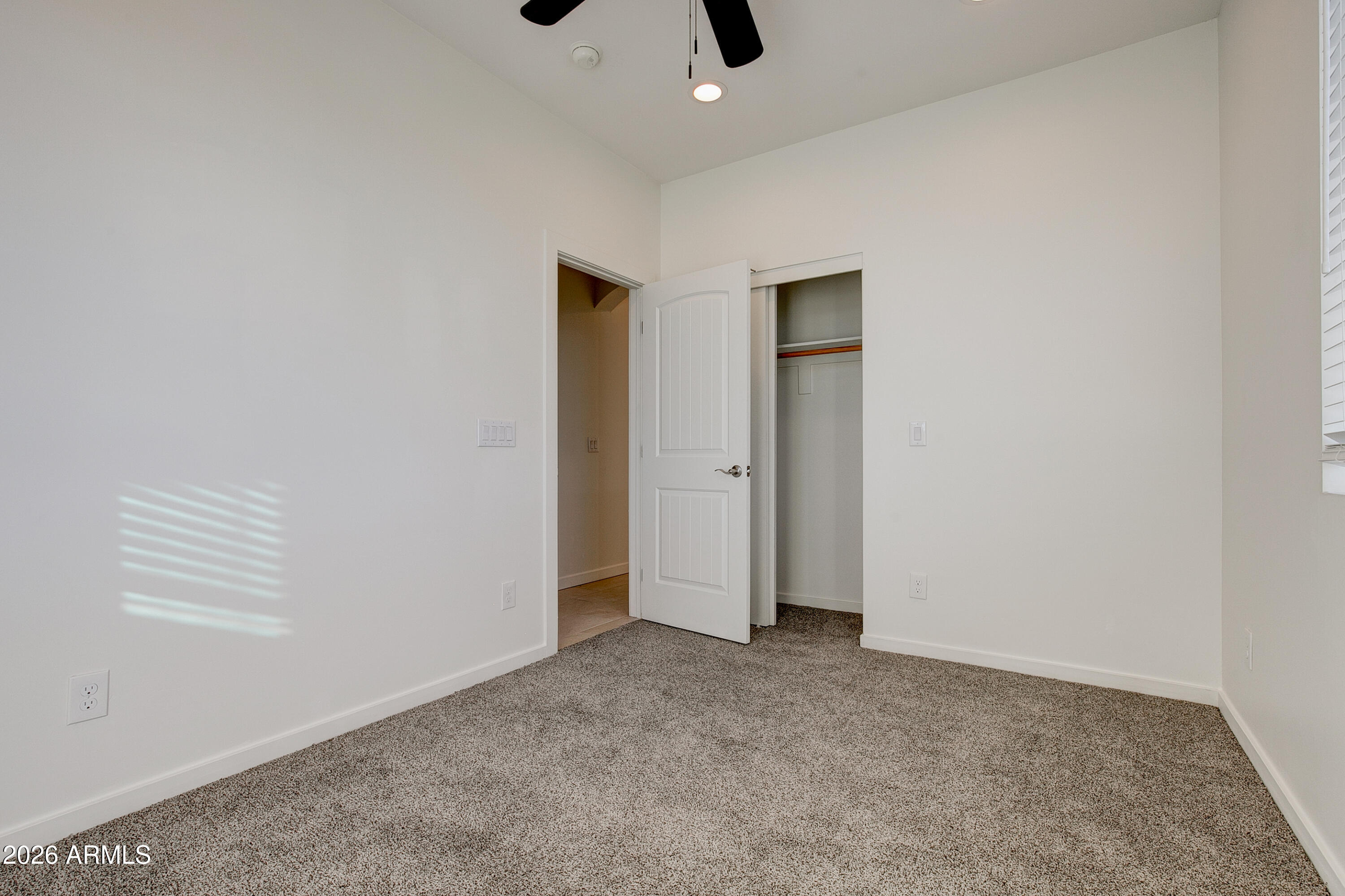16075 North 30th Street Phoenix, AZ 85032 - Photo 27 of 41 an empty room with closet and a ceiling fan
