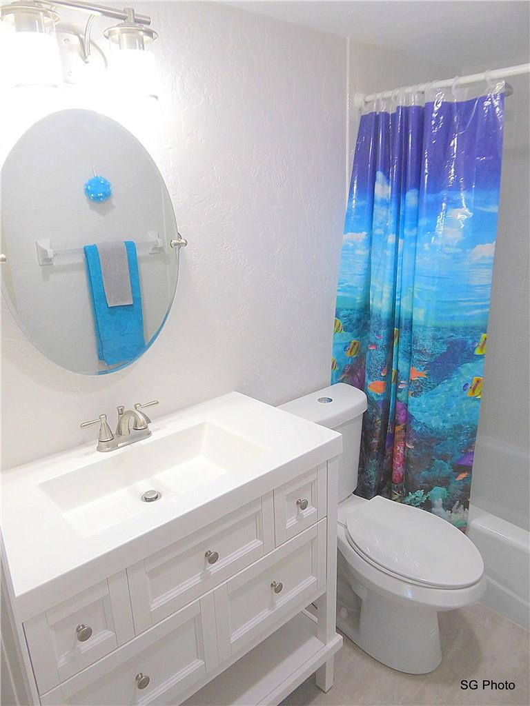 611 East Woolbright Road, Unit 407 Boynton Beach, FL 33435 - Photo 12 of 22 a bathroom with a sink a toilet and shower