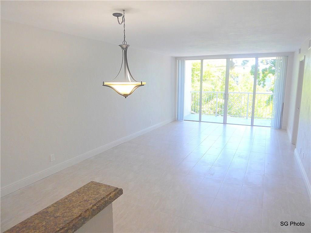 611 East Woolbright Road, Unit 407 Boynton Beach, FL 33435 - Photo 15 of 22 a view of a room with wooden floor and windows