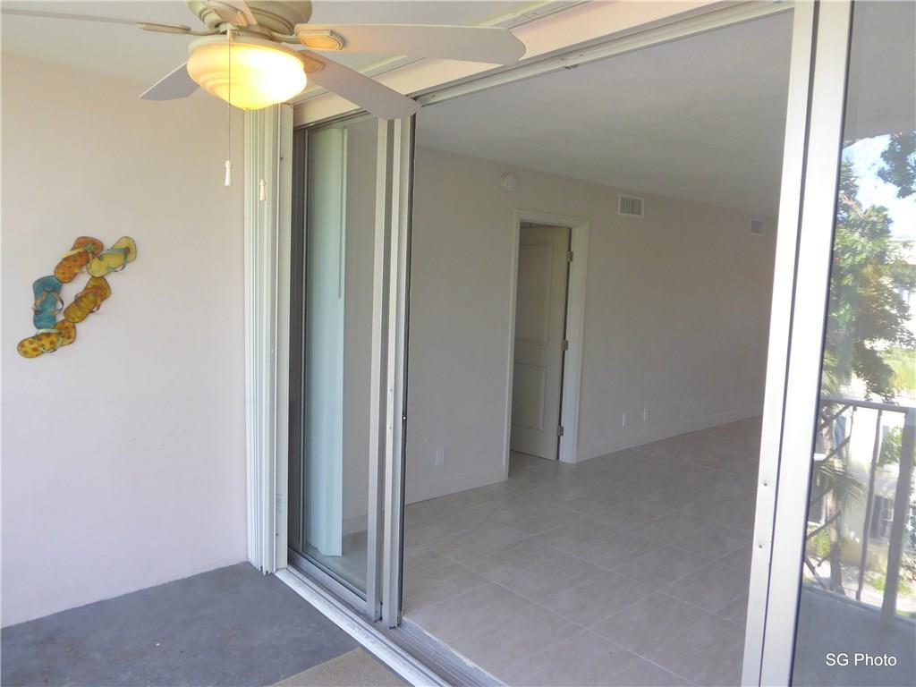 611 East Woolbright Road, Unit 407 Boynton Beach, FL 33435 - Photo 8 of 22 a view of a hallway with a chandelier