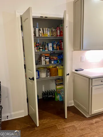 a kitchen with kitchen island granite countertop a sink stainless steel appliances and cabinets
