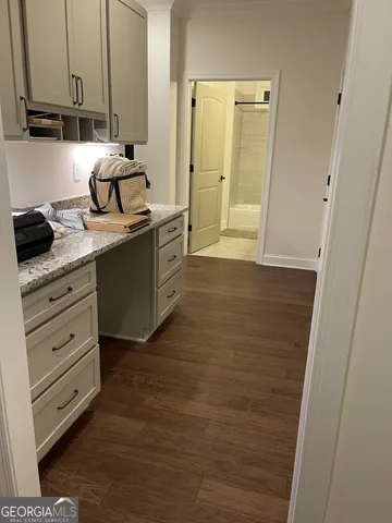 a view of a hallway with wooden floor and furniture