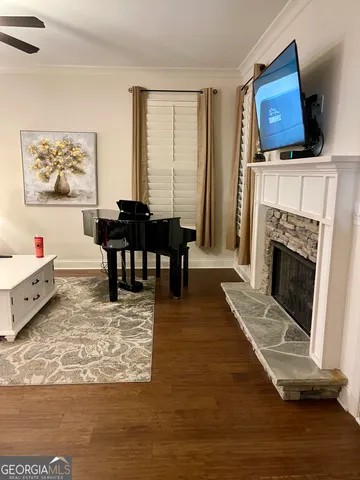 a living room with furniture a fireplace and a flat screen tv