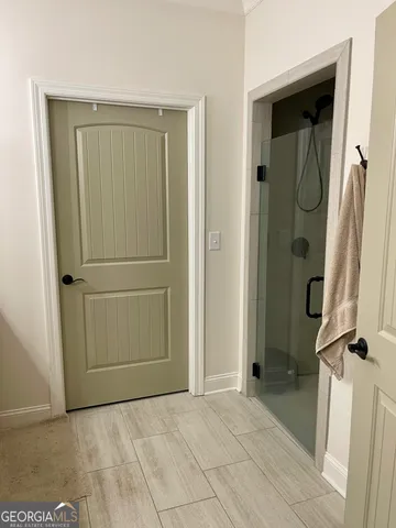 a spacious bathroom with a granite countertop sink and a mirror