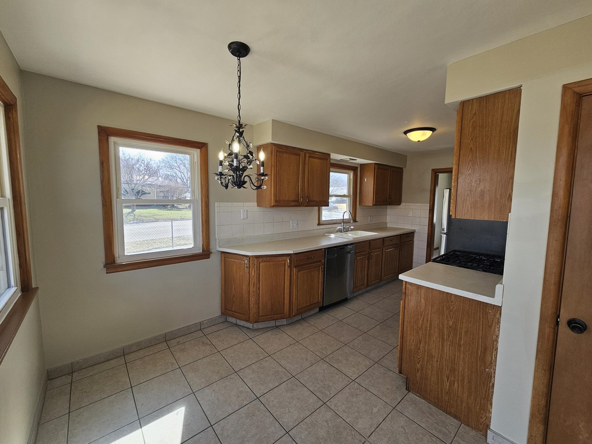 3612 Beach Street Rockford, IL 61108 - Photo 4 of 24 a kitchen with stainless steel appliances granite countertop a sink a counter space and cabinets