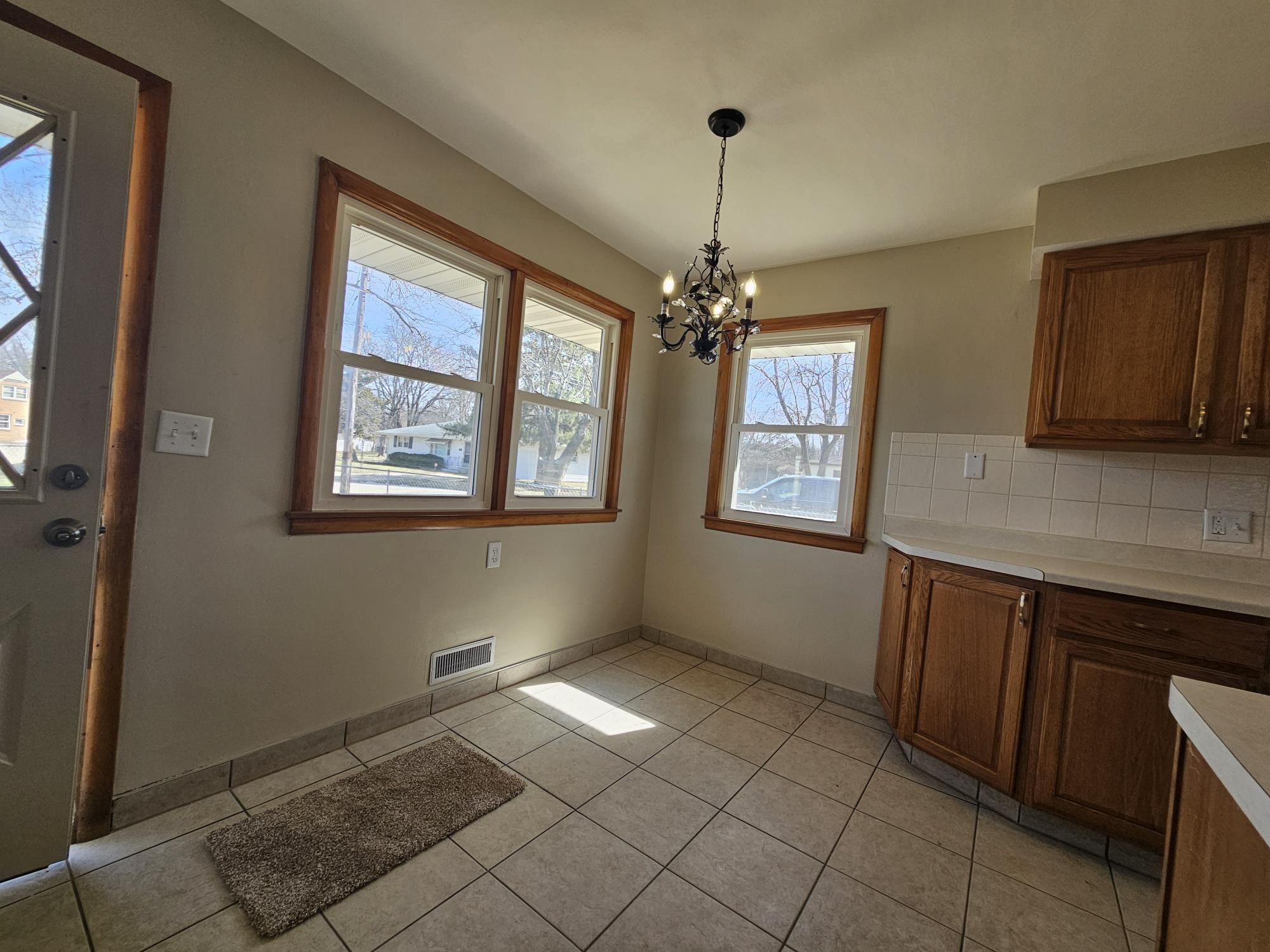 3612 Beach Street Rockford, IL 61108 - Photo 5 of 24 a view of an empty room with window and chandelier