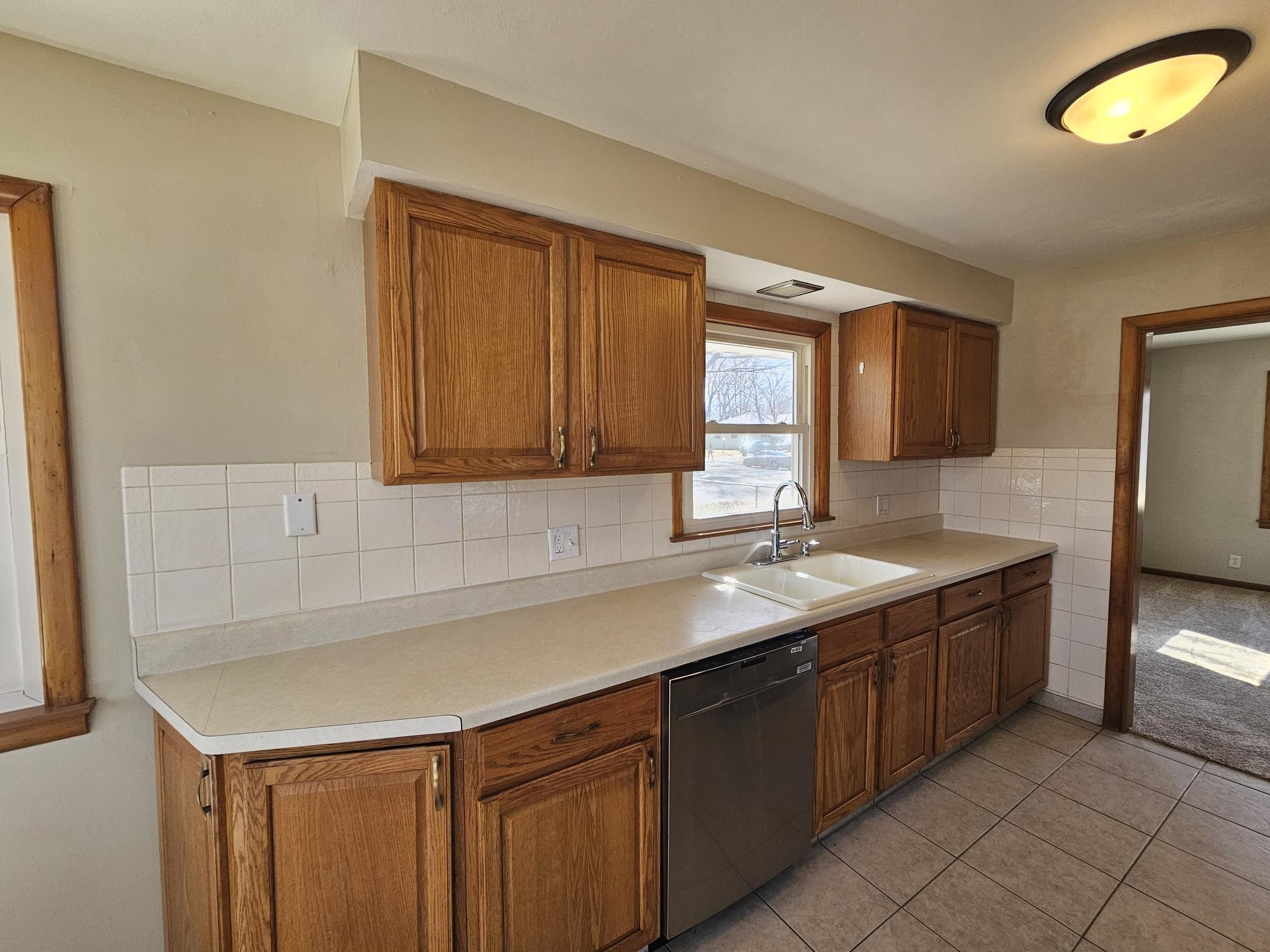 3612 Beach Street Rockford, IL 61108 - Photo 6 of 24 a kitchen with a sink and a refrigerator