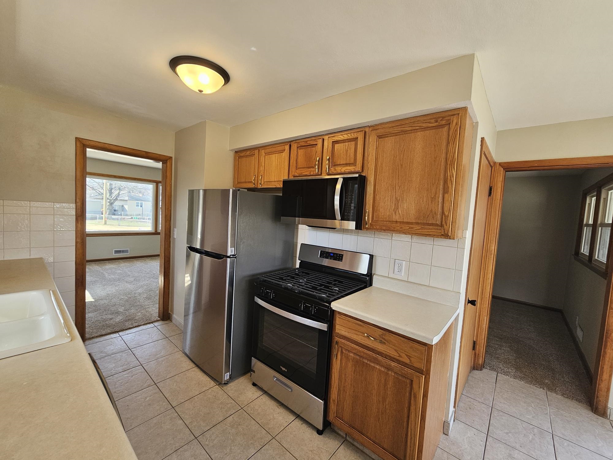 3612 Beach Street Rockford, IL 61108 - Photo 7 of 24 a kitchen with stainless steel appliances granite countertop a refrigerator and a sink