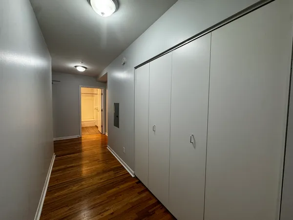 a view of a hallway with wooden floor