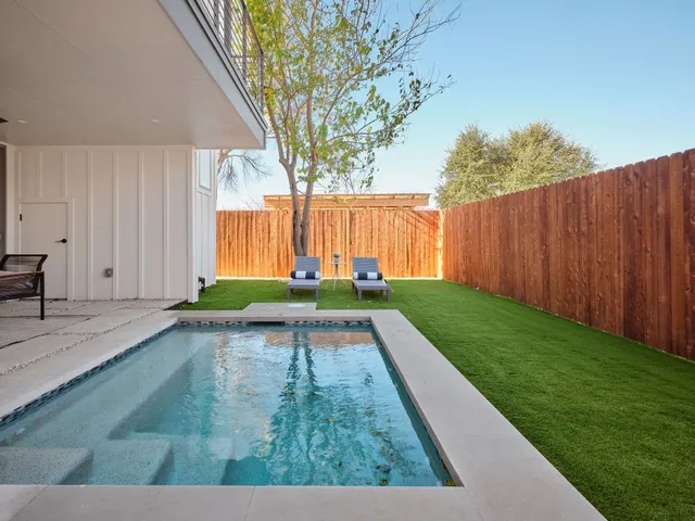 a view of backyard with wooden fence