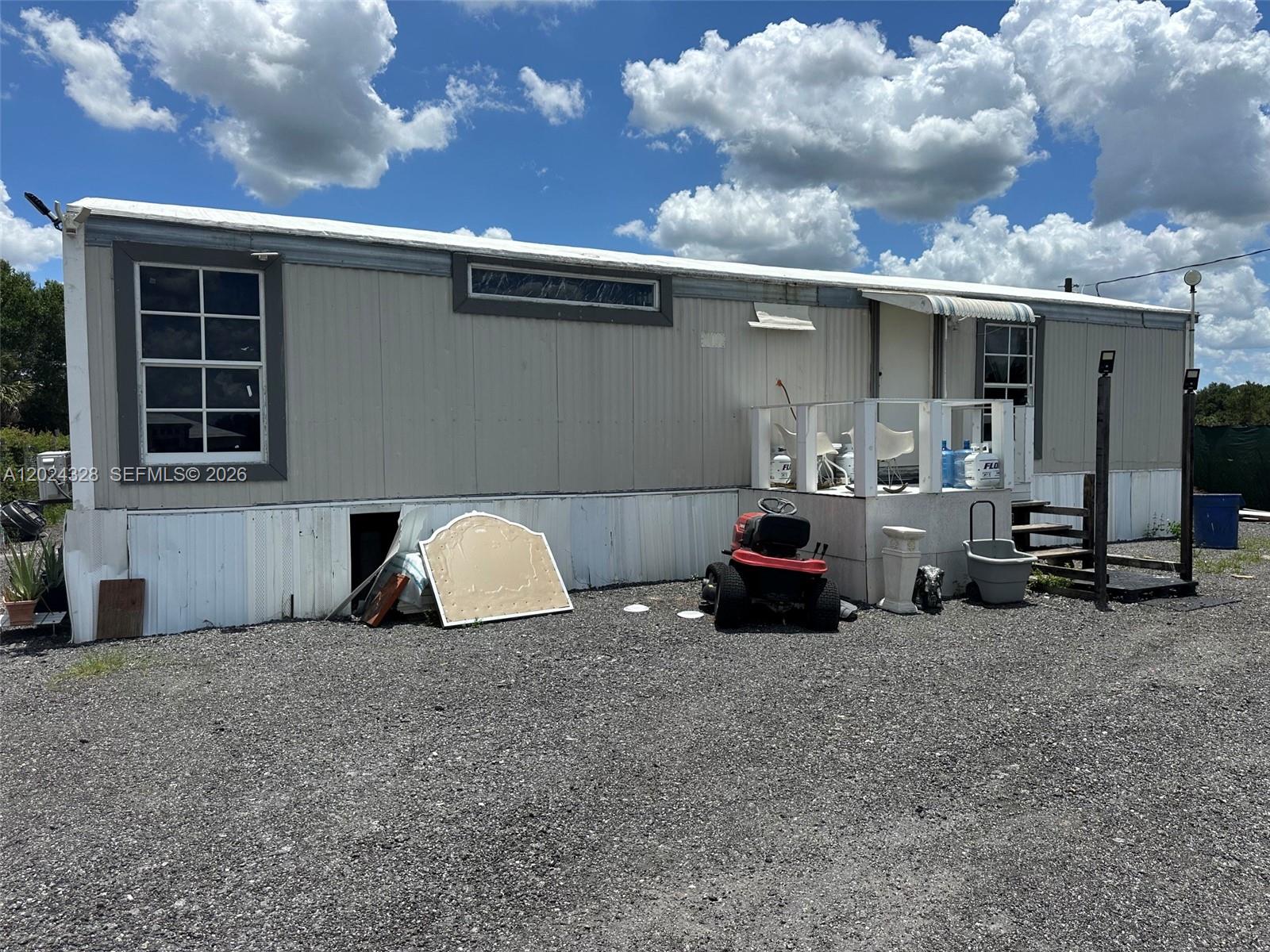 625 North Quebrada Street Clewiston, FL 33440 - Photo 2 of 26 a car parked in front of a house