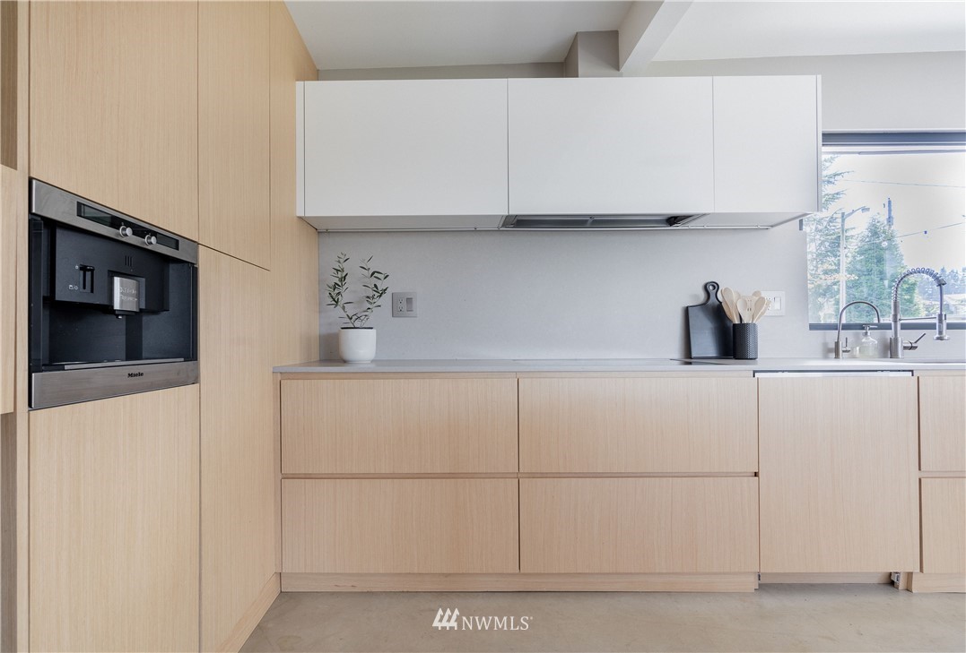 1208 48th Street Southeast Everett, WA 98203 - Photo 14 of 40 a kitchen with a white cabinets and a refrigerator