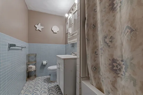 a bathroom with a toilet and a shower