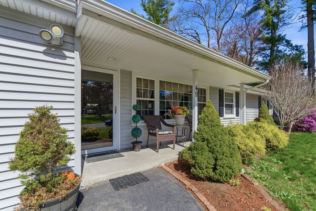 49 Francine Road Raynham, MA 02767 - Photo 2 of 31 a front view of a house with a garden and plants