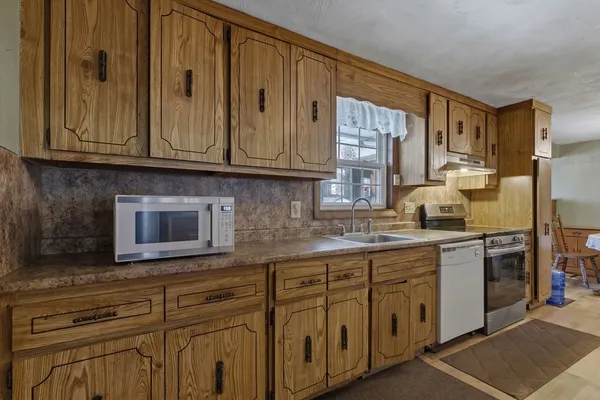 a kitchen with stainless steel appliances granite countertop a sink and cabinets