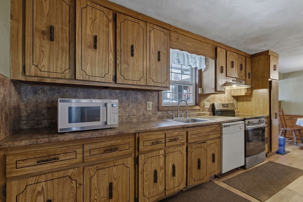 49 Francine Road Raynham, MA 02767 - Photo 3 of 31 a kitchen with stainless steel appliances granite countertop a sink and cabinets