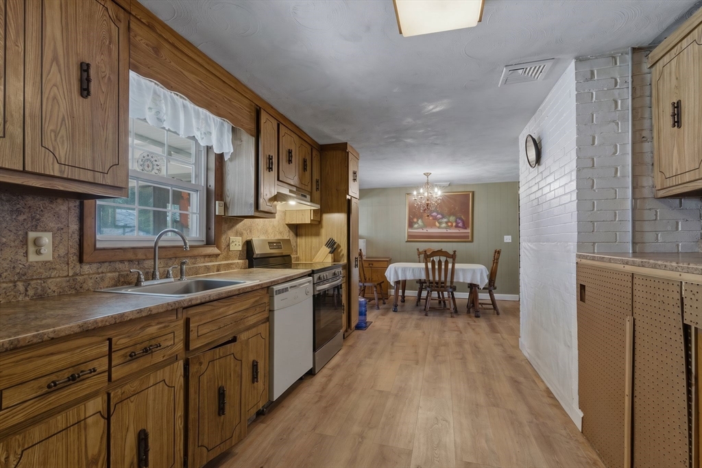 49 Francine Road Raynham, MA 02767 - Photo 4 of 31 a kitchen with sink cabinets and dining table
