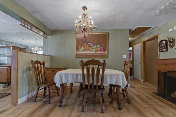 a view of a dining room with furniture wooden floor and chandelier
