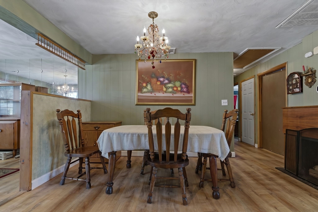49 Francine Road Raynham, MA 02767 - Photo 7 of 31 a view of a dining room with furniture wooden floor and chandelier