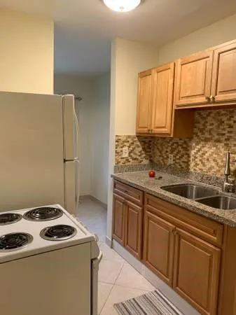 a kitchen that has a sink and a stove