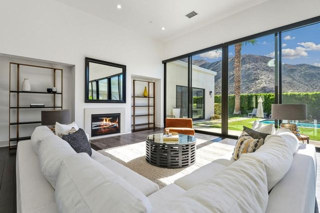 a kitchen that has a lot of cabinets a sink and wooden floor