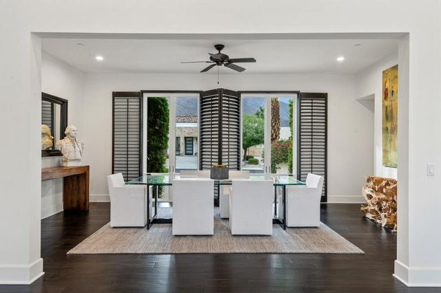 a hallway with a wooden floor and cabinets
