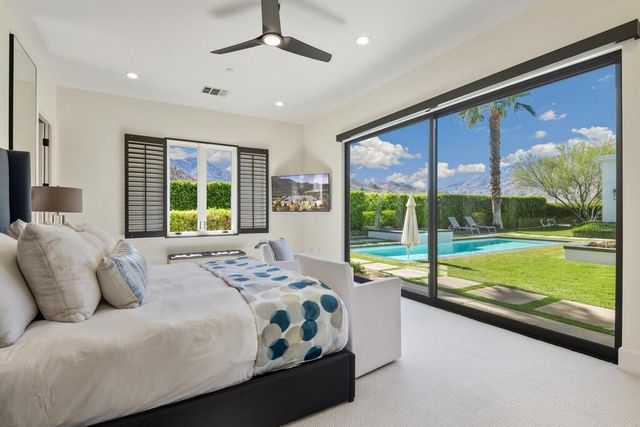 a view of a house with swimming pool and porch with furniture