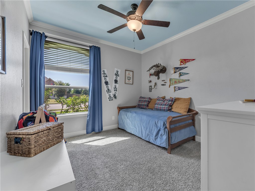 8312 Raintree Drive College Station, TX 77845 - Photo 23 of 30 Bright room featuring a large window with horizontal blinds, light gray walls, and a blue ceiling with a ceiling fan