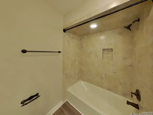 a bathroom with a granite countertop sink toilet and mirror
