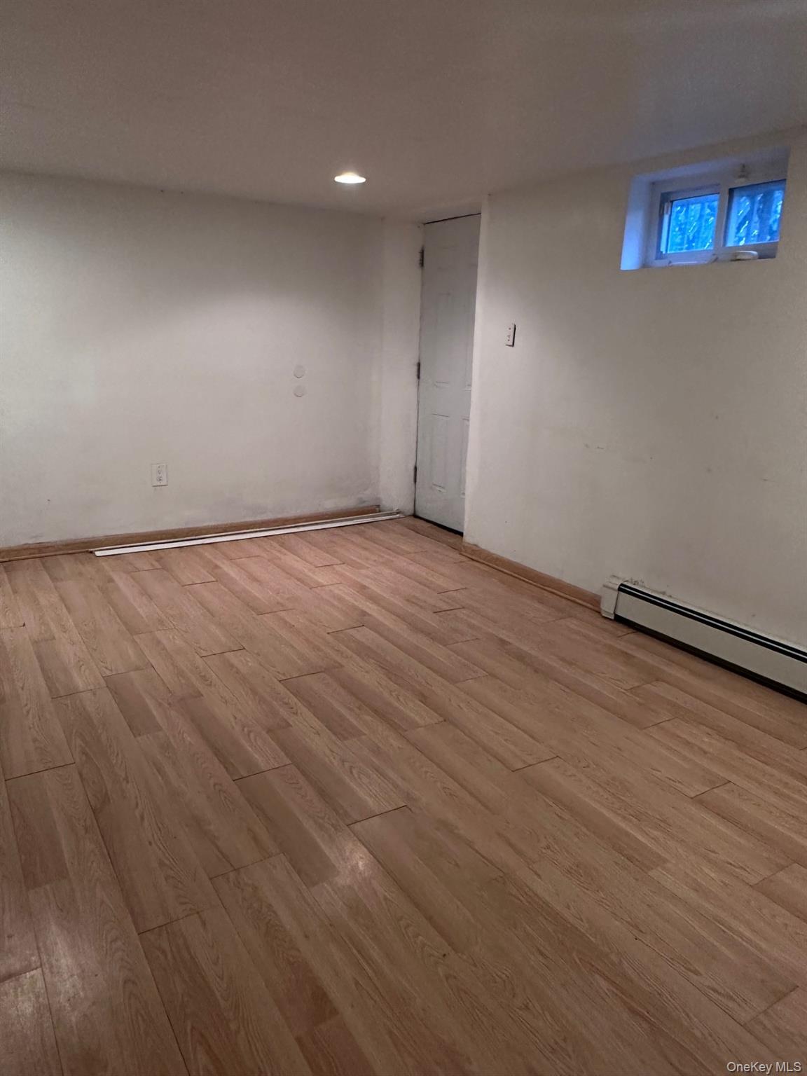 20 Broadway Mastic, NY 11950 - Photo 11 of 11 an empty room with wooden floor