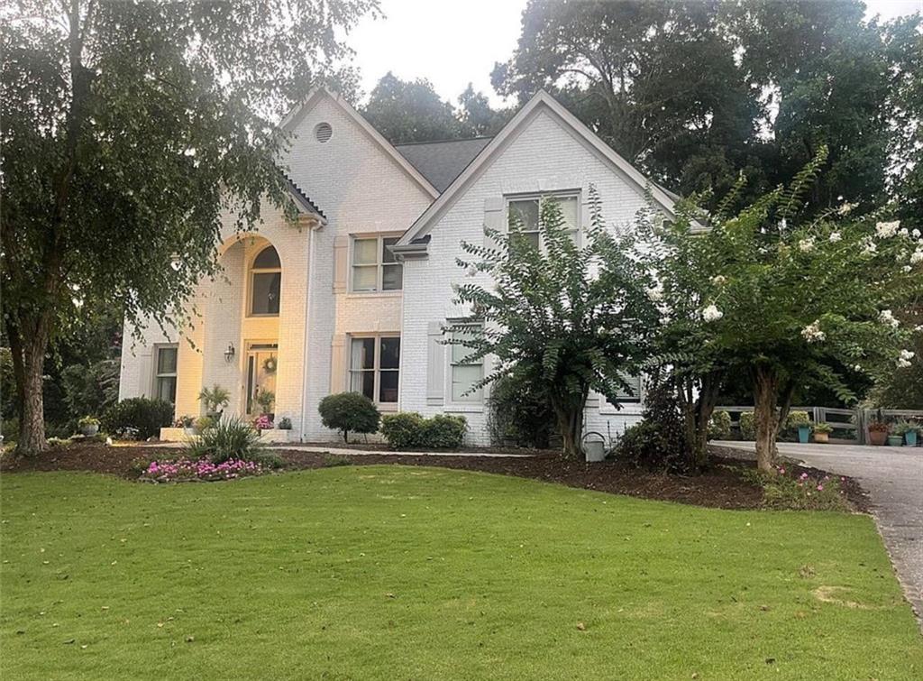 7235 Compton Circle Cumming, GA 30040 - Photo 1 of 1 a front view of a house with garden