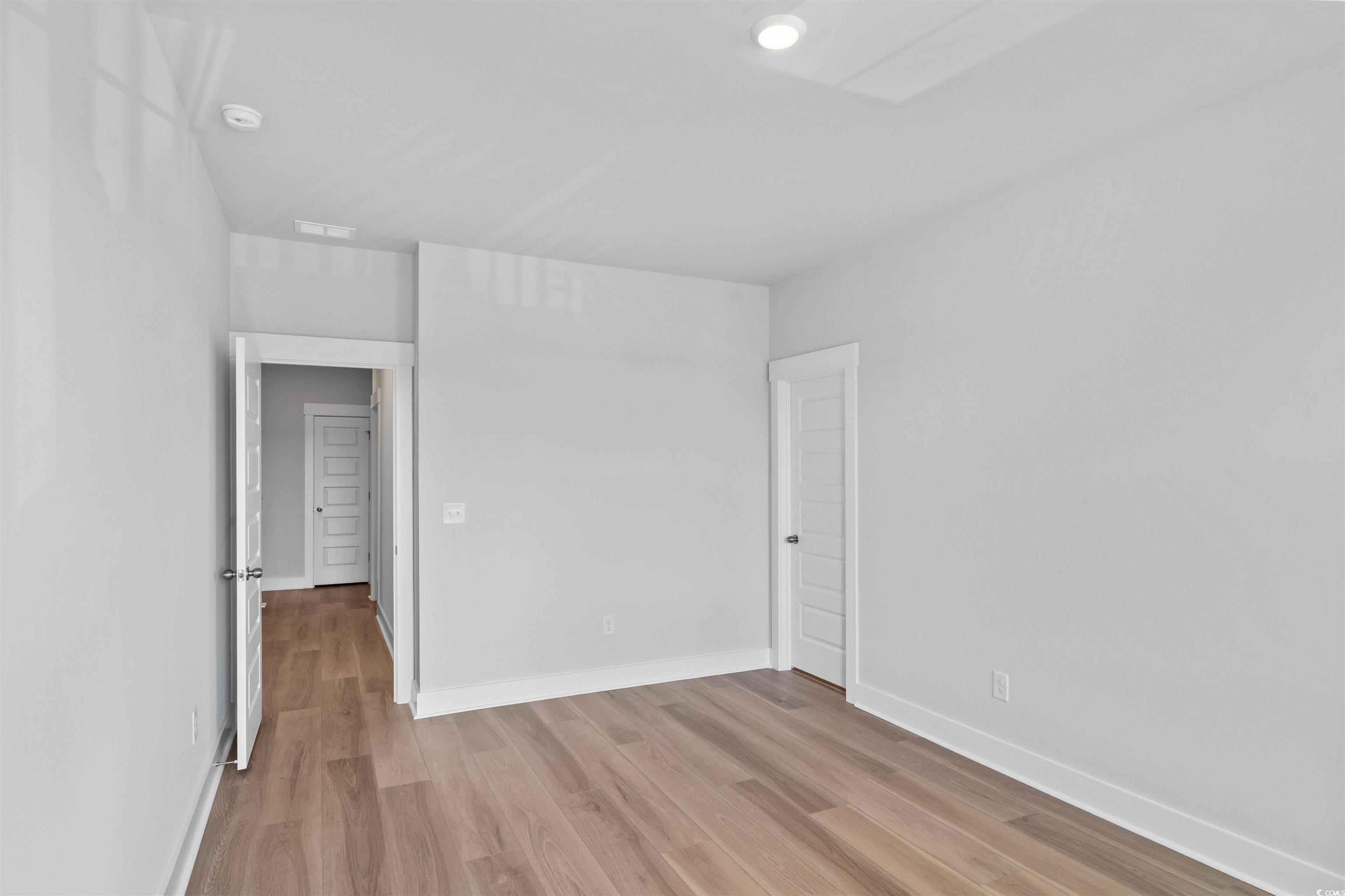 220 Atlantic Breeze Street Myrtle Beach, SC 29572 - Photo 7 of 38 Spare room with light wood finished floors and baseboards