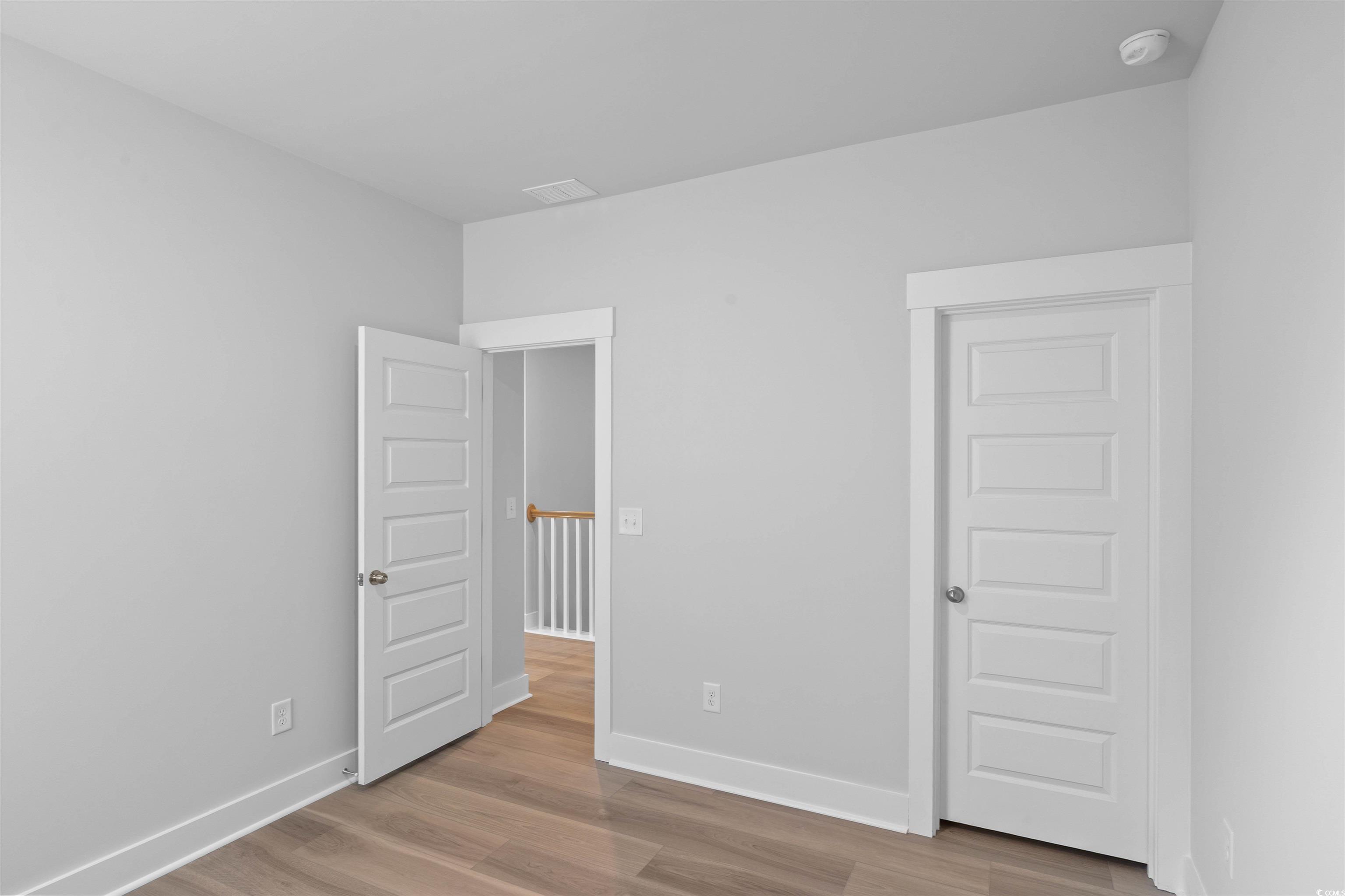 220 Atlantic Breeze Street Myrtle Beach, SC 29572 - Photo 9 of 38 Unfurnished bedroom featuring light wood-style floors and baseboards