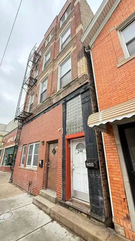 a kitchen with granite countertop a refrigerator and a stove top oven