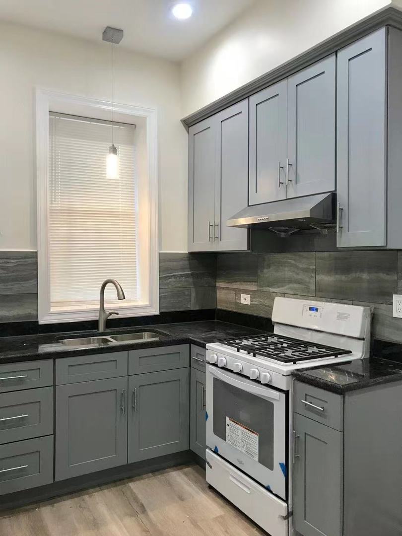 248 West 26th Street Chicago, IL 60616 - Photo 5 of 9 a kitchen with granite countertop a sink a stove and cabinets