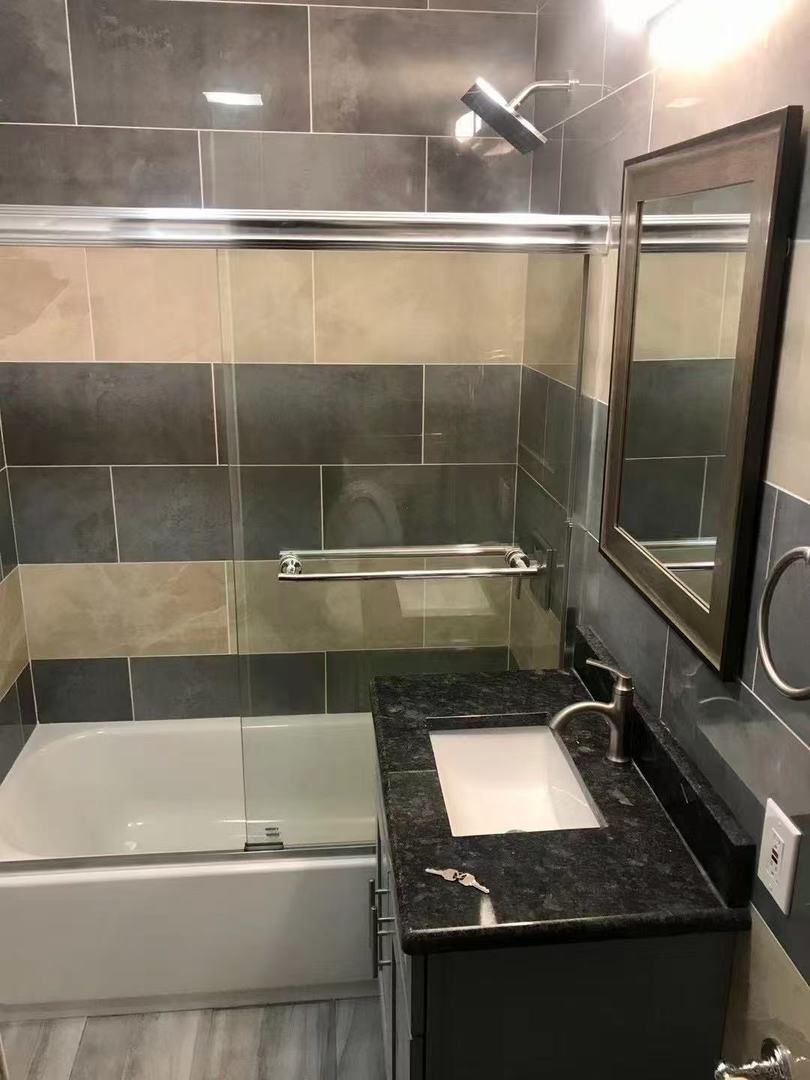 248 West 26th Street Chicago, IL 60616 - Photo 6 of 9 a bathroom with a granite countertop sink a mirror and a shower