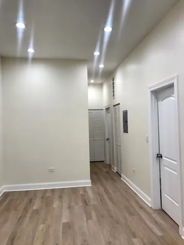 a view of an empty room with wooden floor