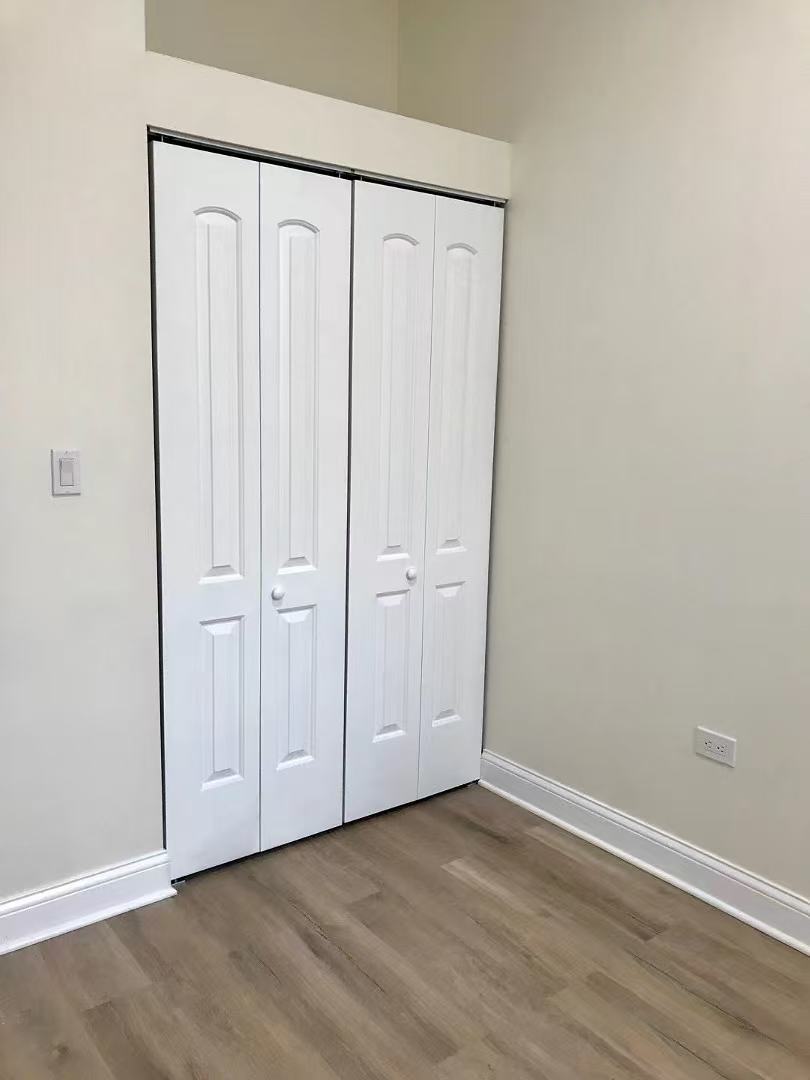 248 West 26th Street Chicago, IL 60616 - Photo 8 of 9 a view of an empty room with wooden floor