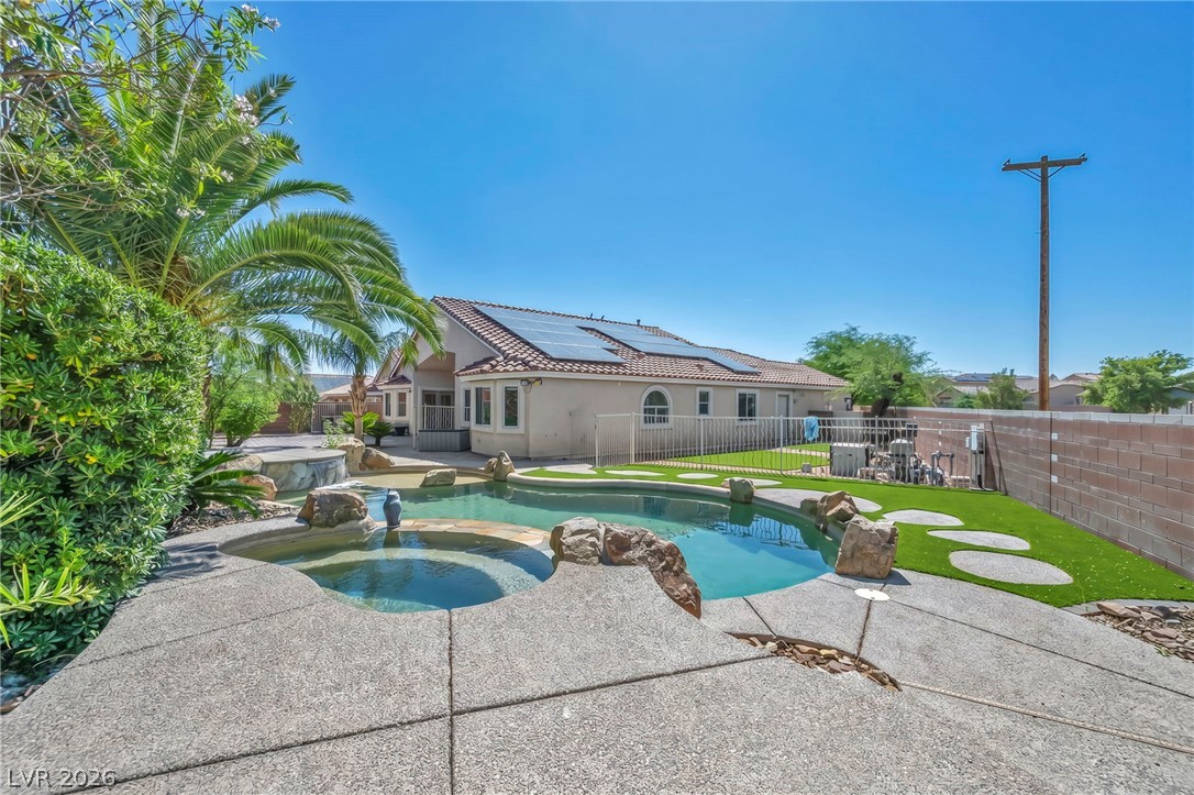 6405 North Raptor Court North Las Vegas, NV 89084 - Photo 48 of 66 Your private backyard oasis features a shimmering pool, spa, and sun-drenched patio.
